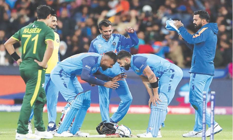 MELBOURNE: India&rsquo;s Virat Kohli (second R) celebrates with Hardik Pandya as their other teammates look on after a thrilling last-ball victory in the T20 World Cup match against Pakistan at the Melbourne Cricket Ground on Sunday. Kohli&rsquo;s magnificent, game-changing innings of 82 not out guided India to a four-wicket win in the Group 2 opener.&mdash;AFP / Text by Umaid Wasim