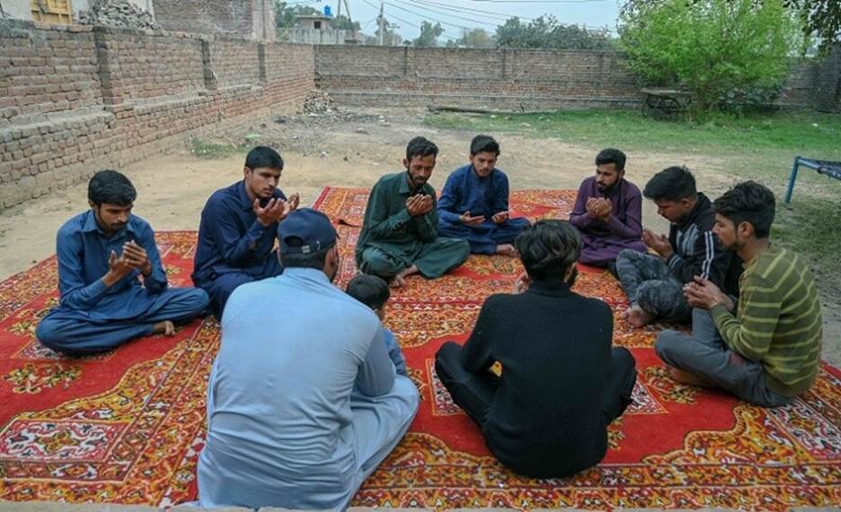  In this picture taken on March 2, 2023, mourners pray for Muhammad Nadeem, near his house in Gujrat district of Punjab province, who died in Libya boat capsizing along with other migrants. &mdash; AFP 