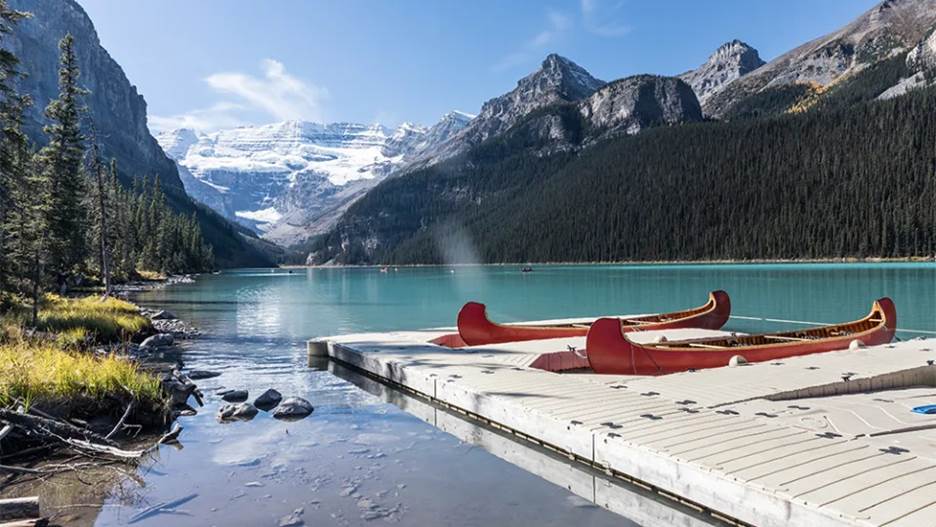 This is where you&rsquo;re headed: the stunning, turquoise Lake Louise, nestled into the mountains.
