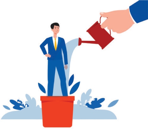 A hand pouring water from a watering can to a person in a suit Description automatically generated