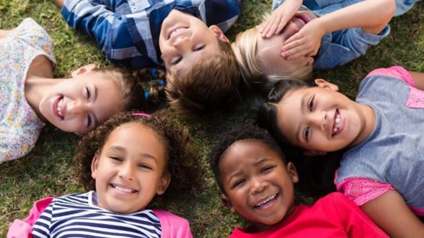 A group of children lying in a circle AI-generated content may be incorrect.