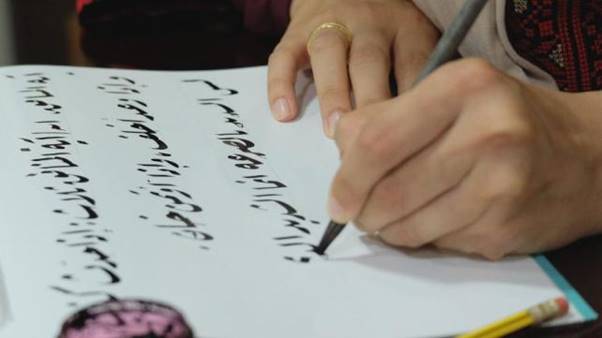 A person writing on a piece of paper AI-generated content may be incorrect.