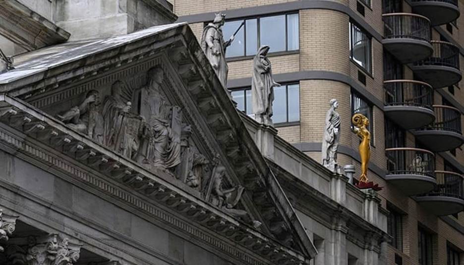 Shahzia Sikanders sculpture (right) stands atop the courthouse of the Appellate Division First Department of the Supreme Court near Madison Square Park as part of her multimedia exhibition to breathe, air, life on February 7, 2023, in New York City. &mdash; AFP