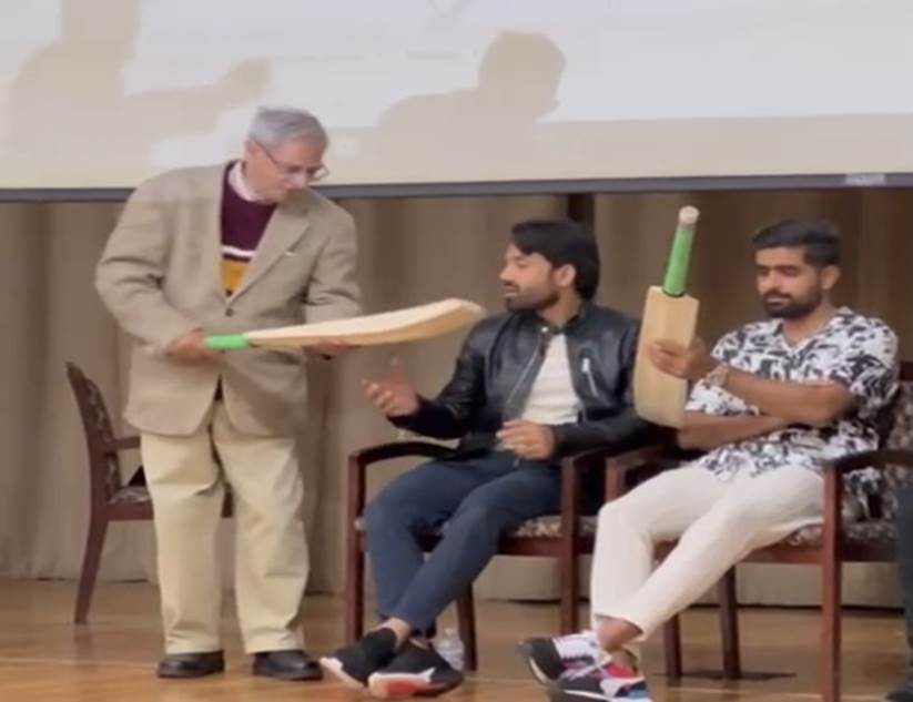 A group of men sitting in chairs Description automatically generated