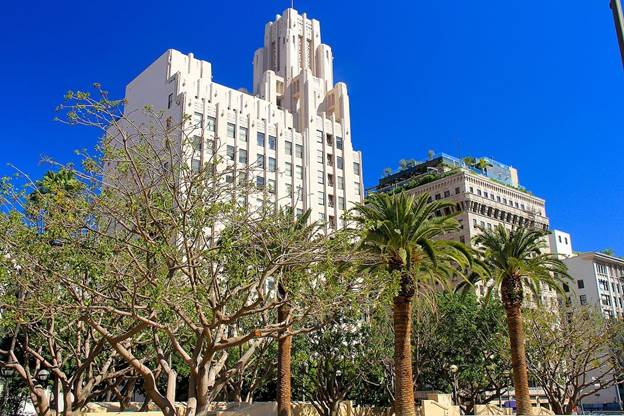 A tall building with trees in front of it  Description automatically generated