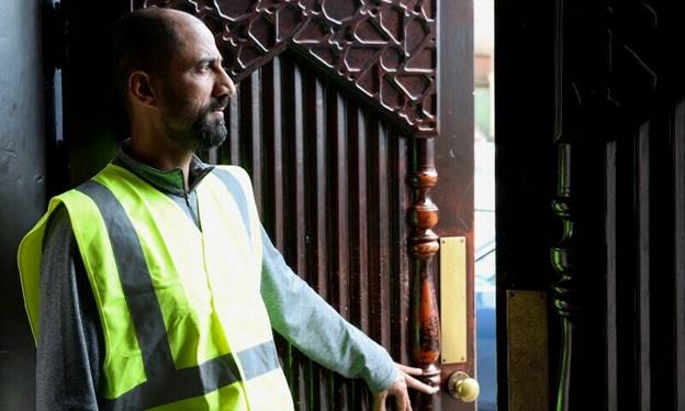A volunteer monitors the surroundings of the Al Rahma Mosque, amid rioting across the country in which mosques and Muslims have been targets, in Liverpool, Britain, August 6. &mdash; Reuters