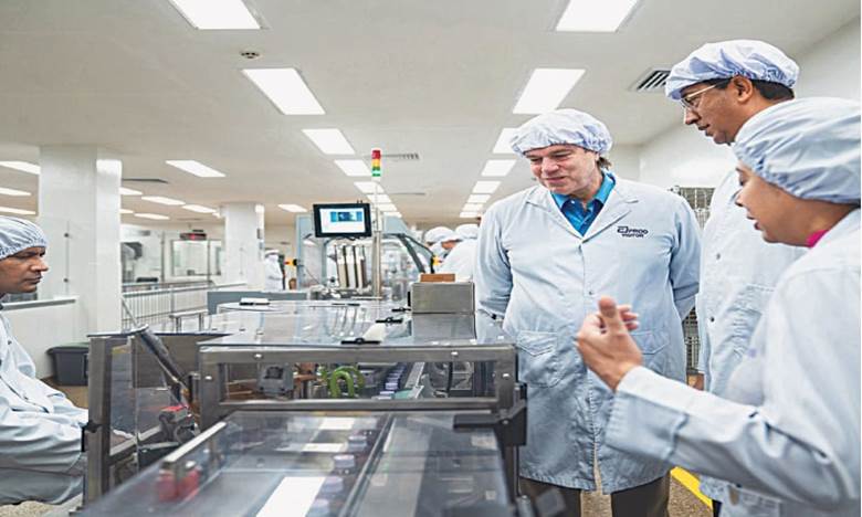 US diplomat Andrew Schofer watches work at a pharmaceutical firm in Karachi.&mdash;Dawn