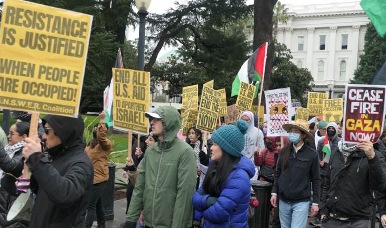 A group of people holding signs Description automatically generated