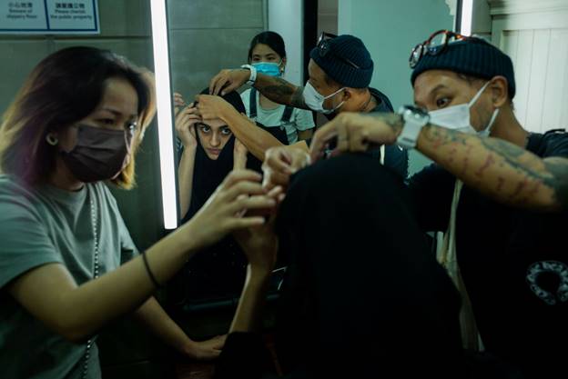 A group of people wearing masks Description automatically generated