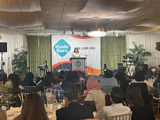 A person standing at a podium in front of a group of people AI-generated content may be incorrect.