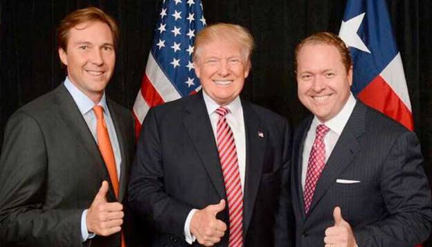 Donald Trump (centre) and Gentry Beach (right) gesture in this file photo. &mdash; Reporter