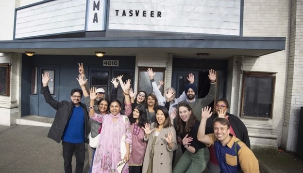 A group of people posing for a photo outside of a building AI-generated content may be incorrect.