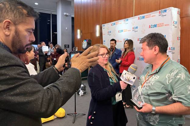 A person taking a picture of a person with microphones AI-generated content may be incorrect.