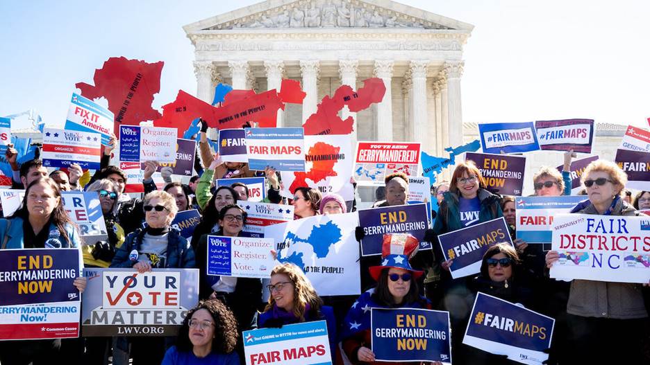 A group of people holding signs  Description automatically generated