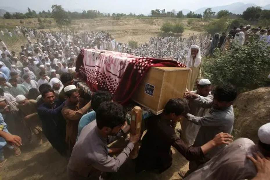 A group of people carrying a coffin Description automatically generated