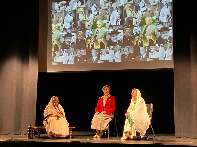 A group of women sitting on a stage  Description automatically generated