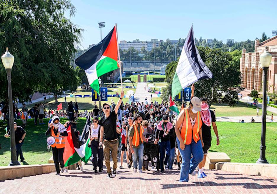 A group of people walking down a path with flags Description automatically generated