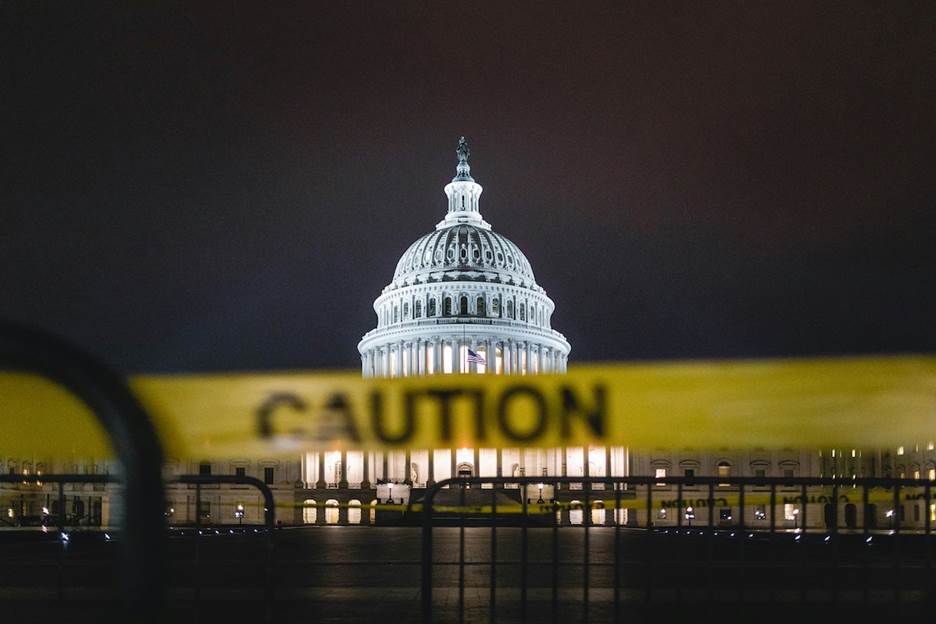 A caution tape in front of a building Description automatically generated