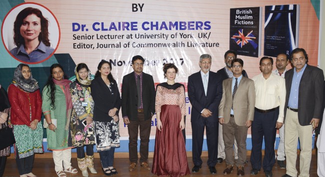 A group of people standing in front of a banner  Description automatically generated
