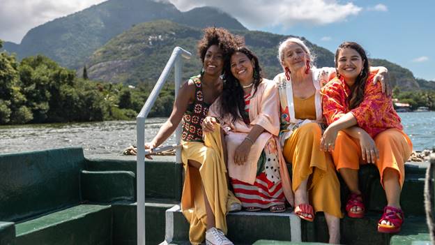 A group of women sitting on a boat  Description automatically generated