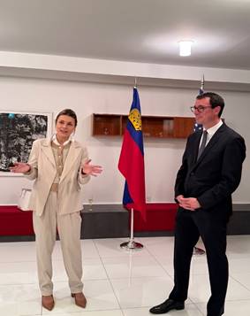 A person and person standing in a room with flags AI-generated content may be incorrect.