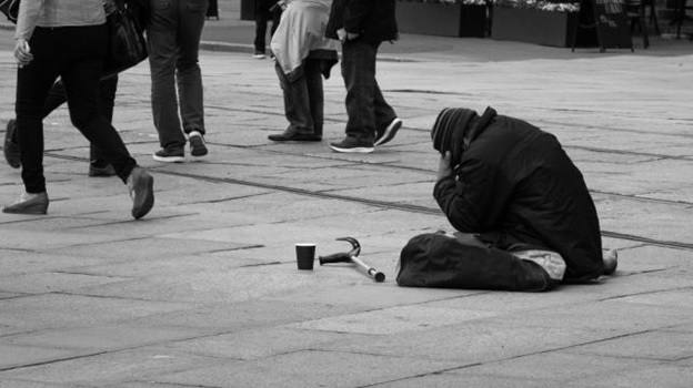 A person sitting on the ground with a hammer and a cup AI-generated content may be incorrect.