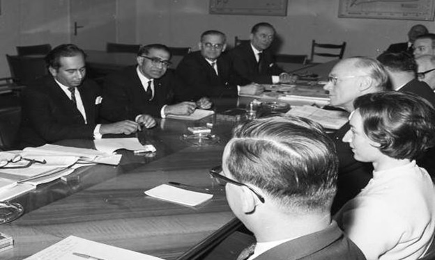 A group of people sitting around a table AI-generated content may be incorrect.