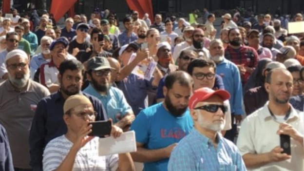 A group of people standing in a crowd AI-generated content may be incorrect.