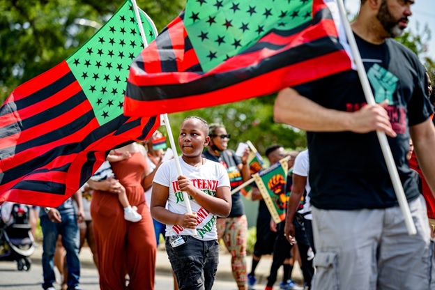 A group of people holding flags  AI-generated content may be incorrect.