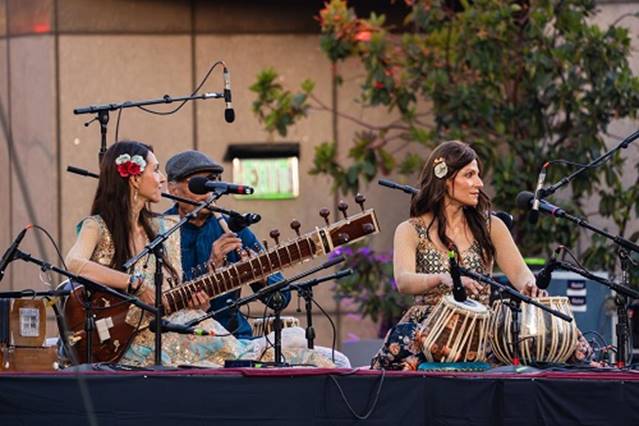 A group of people playing instruments AI-generated content may be incorrect.